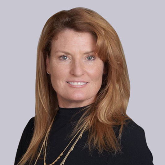 A headshot of Colleen Ritchie, Senior Vice President and Chief Experience Officer at Gainwell Technologies, smiling wearing a black sweater and necklaces.
