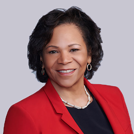 A headshot of Karen Shields, Strategic Advisor at Gainwell Technologies, smiling in a red and black suit.