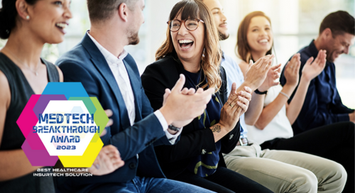 A diverse group of professionals sitting in a row smiling, laughing, and clapping in a conference setting. Overlaying the image is the MedTech Breakthrough Award logo.
